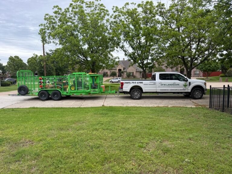DFW Landscape and Lighting Solutions truck and landscape trailer at a property