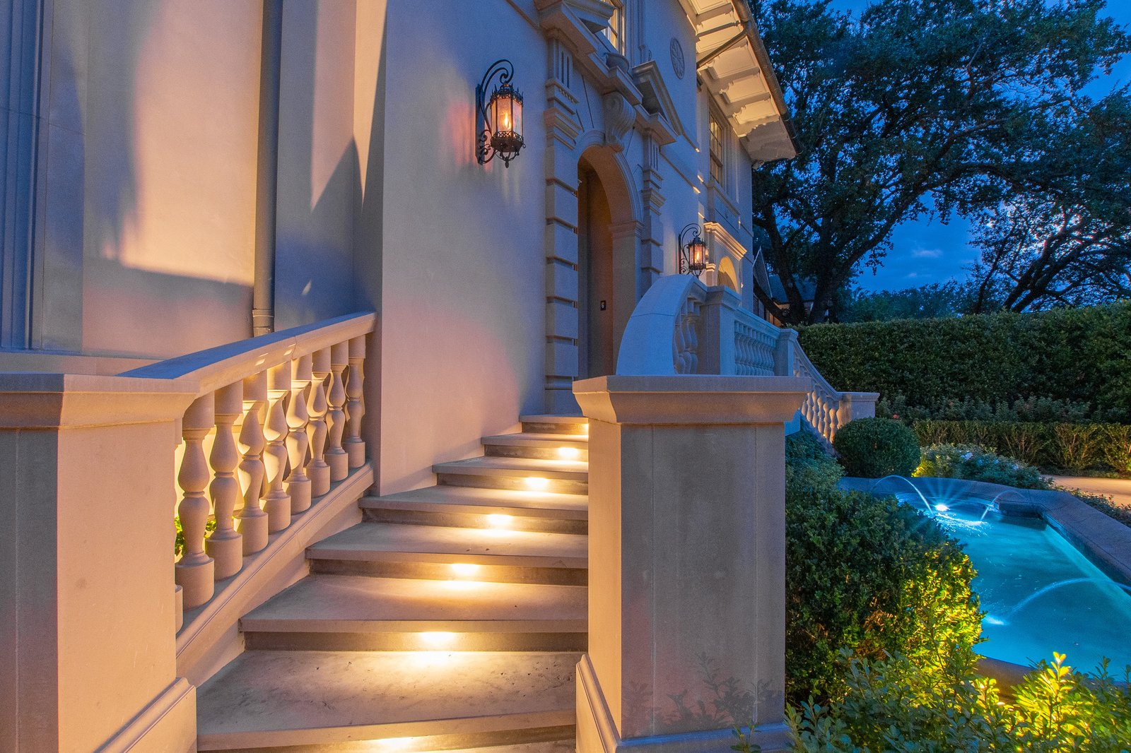 Lighted stone steps at a home entrance at night