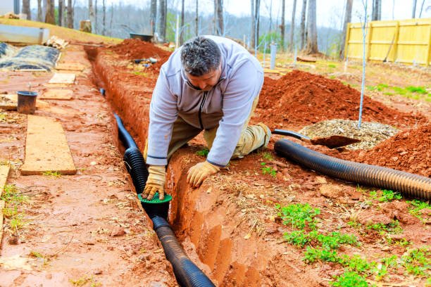 Drainage pipe installation in a landscaped trench